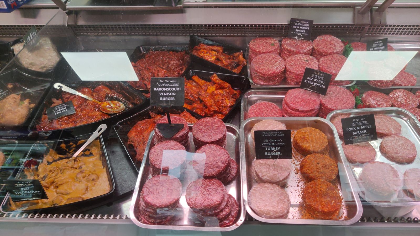 Burger counter with Baronscourt venison, Wagyu, New Yorker, turkey and pork and apple burgers beside beef stroganoff and chicken stir fry